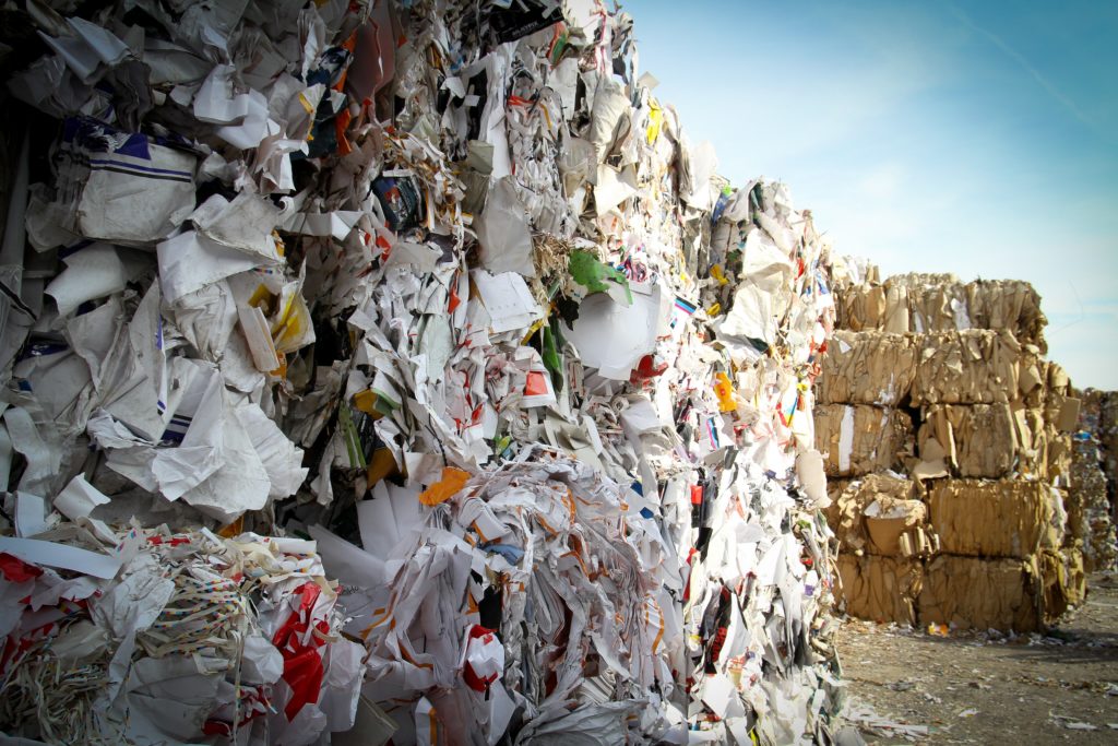 A wall of stacked bales of compacted paper waste