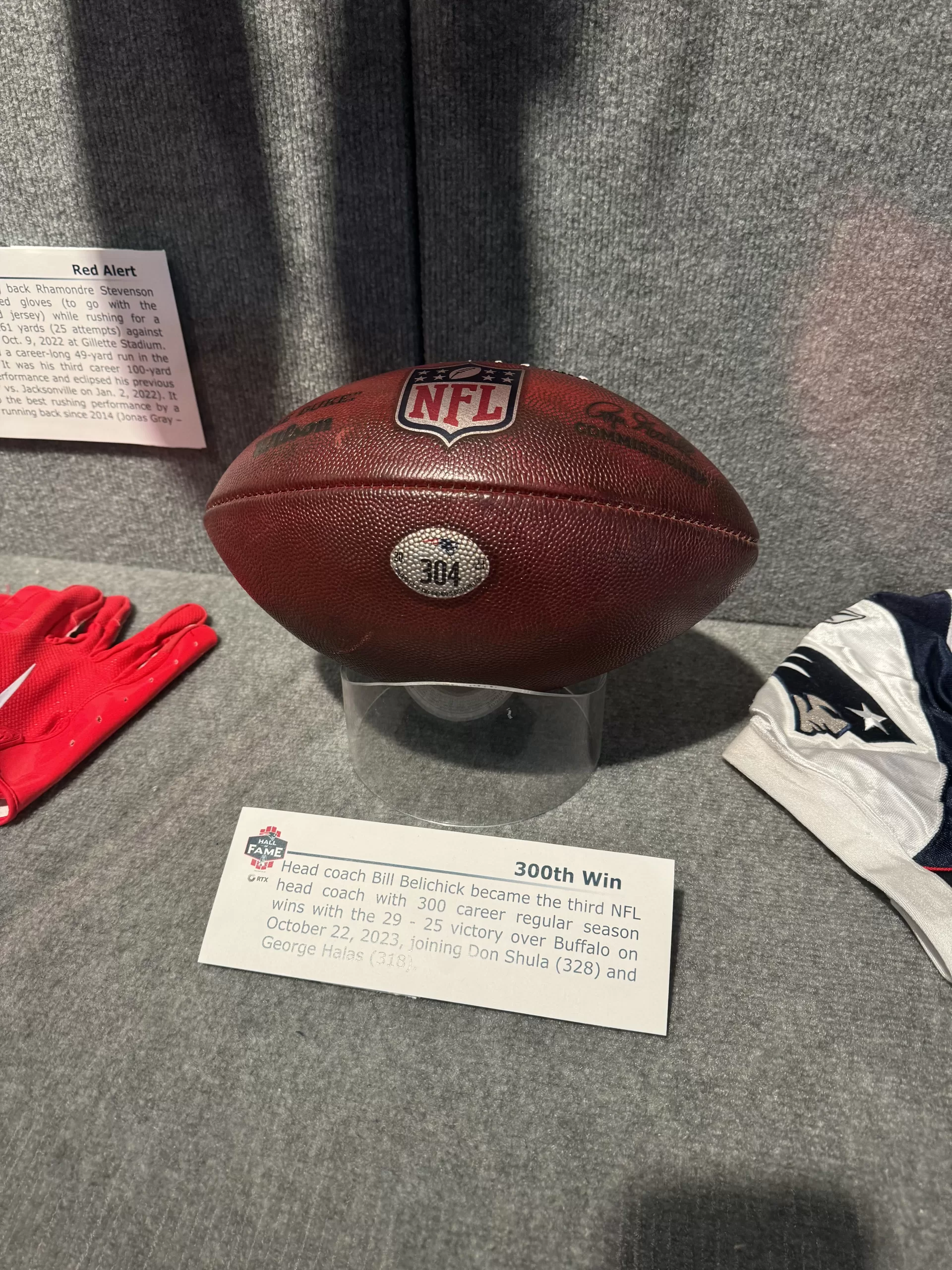 A football in a museum. The football was in a game of NFL football from the New England Patriots vs. the Buffalo Bills on October 22, 2023. The Patriots won giving Bill Belichick his 300th career win as a head coach. 