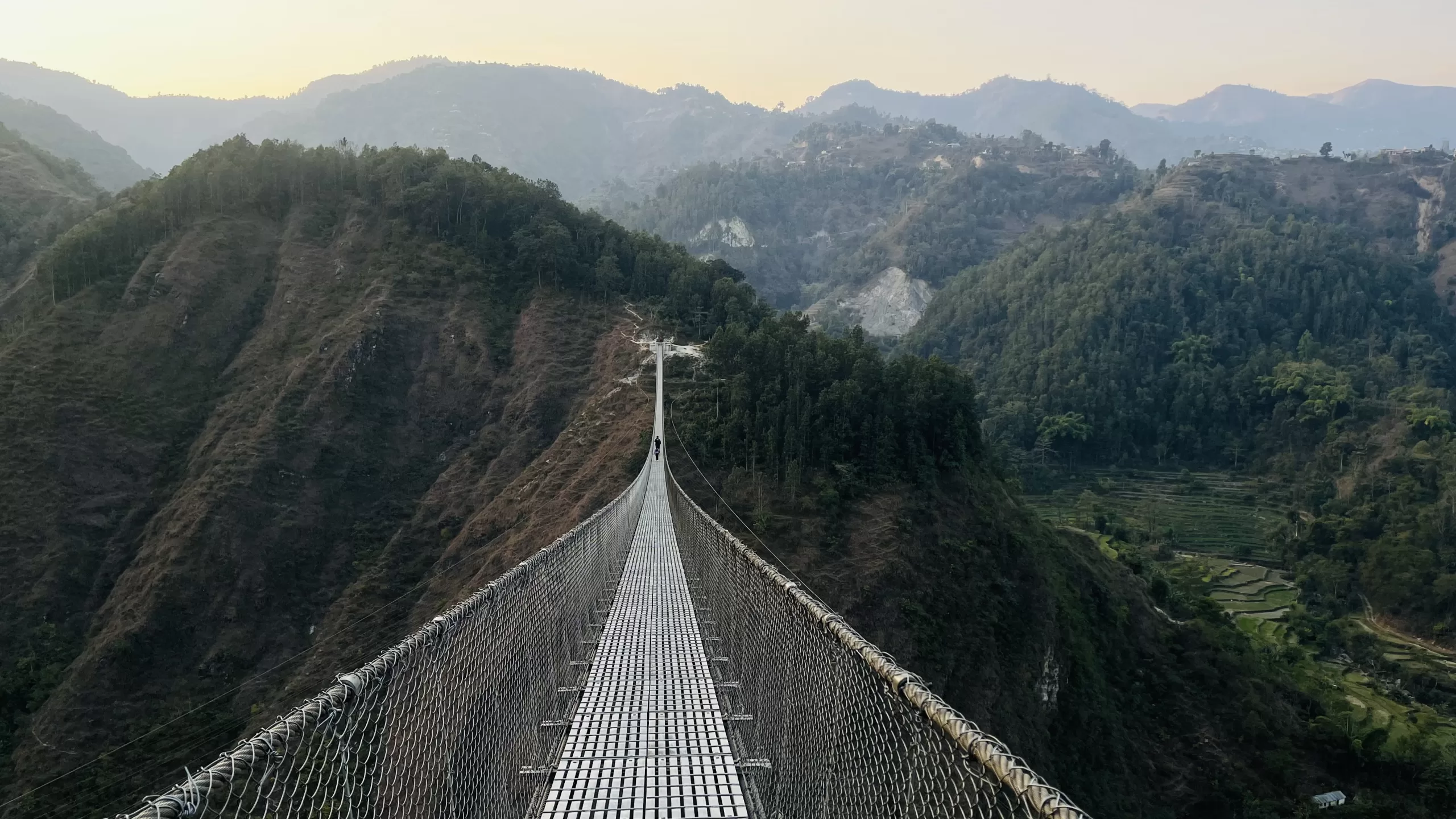 Suspension bridge connecting mountains.