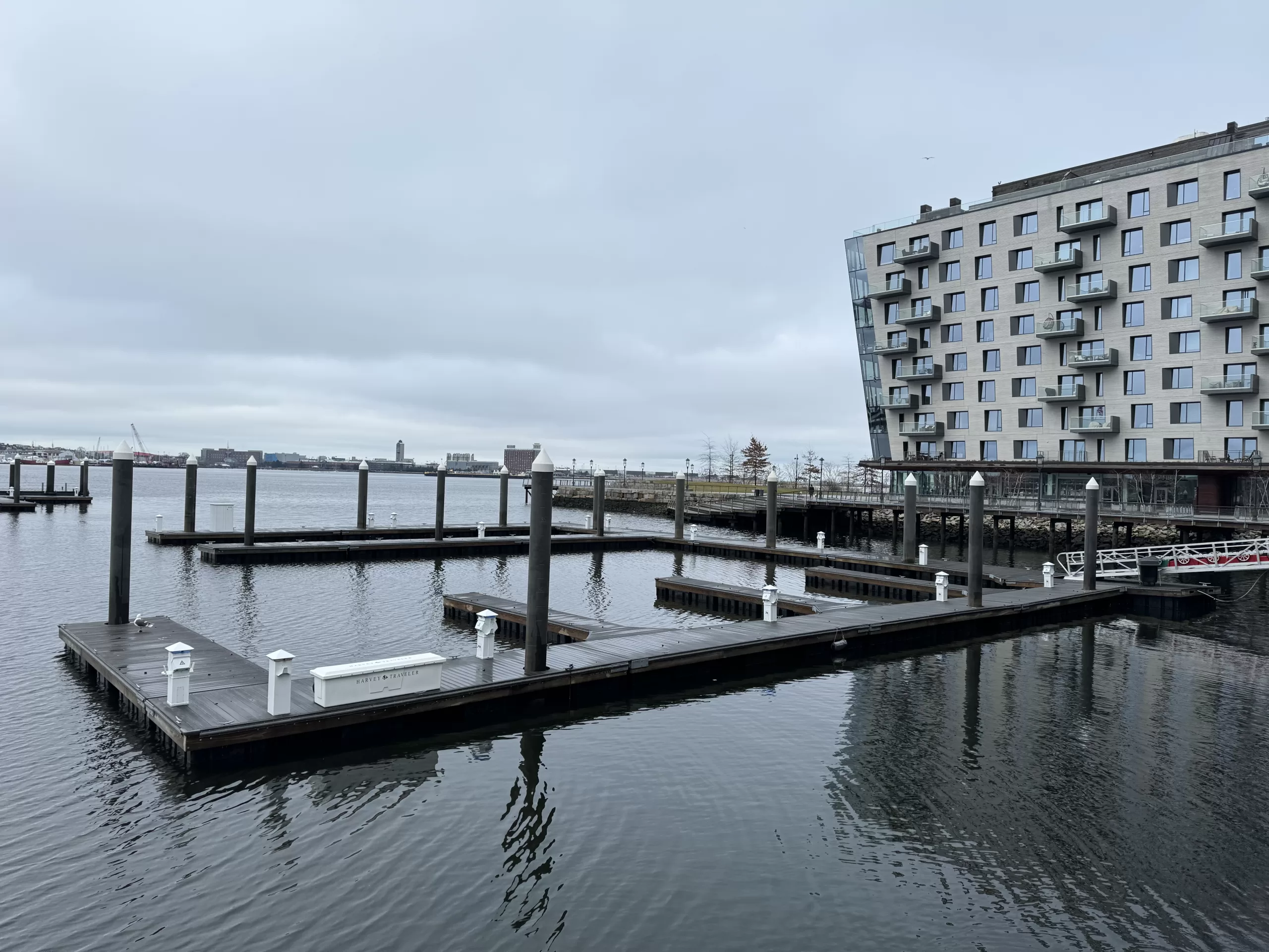 An empty dock on a cloudy day in Boston’s Seaport District overlooking the Boston Main Channel.