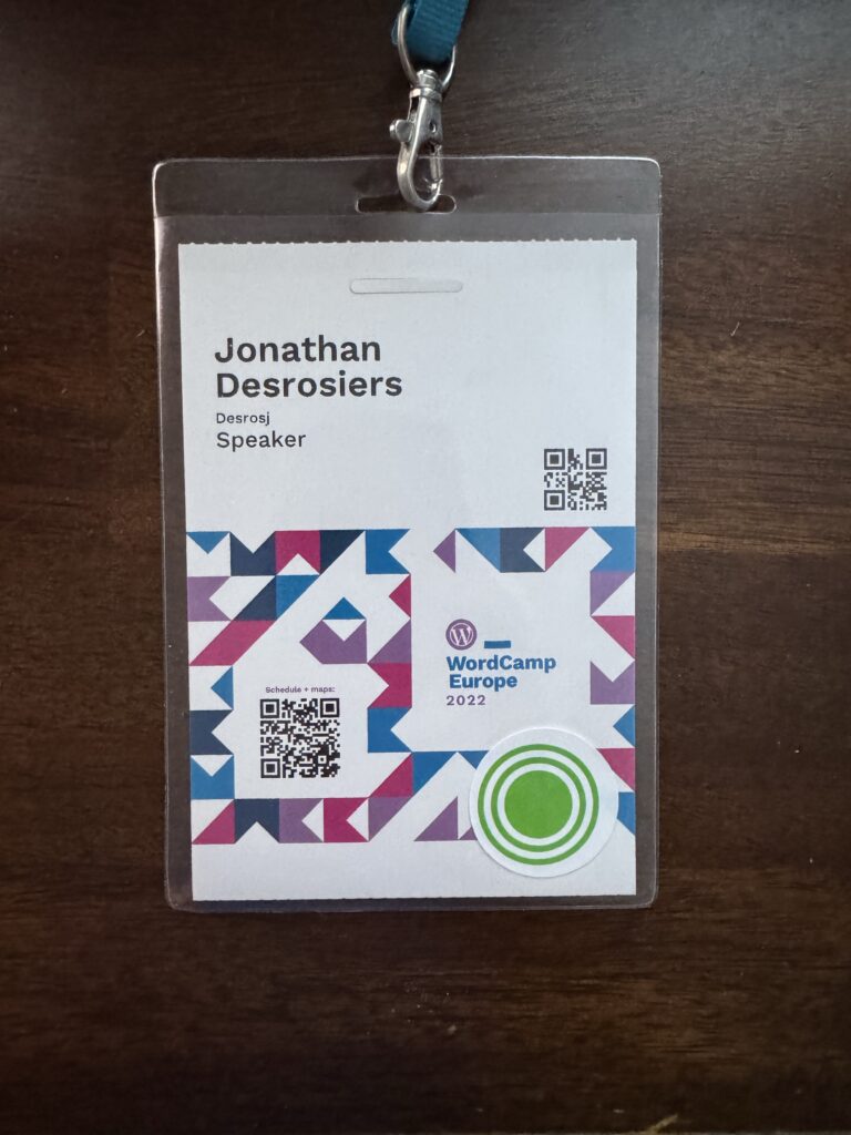 My WordCamp Europe 2022 speaker badge consisting of an event branded badge with my name printed on.
