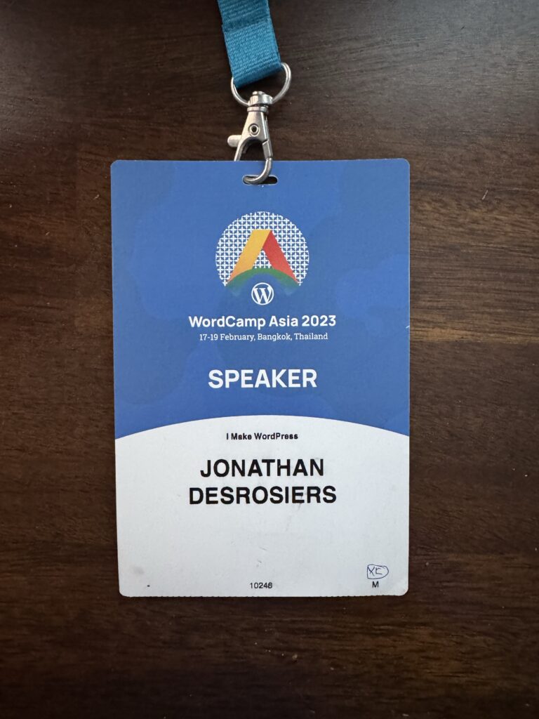 My WordCamp Asia 2023 speaker badge consisting of an event branded badge with my name printed on.