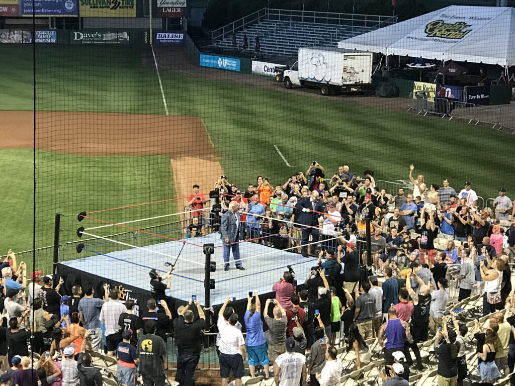 Ric Flair in a wrestling ring set up at home plate at McCoy Stadium in Pawtucket, Rhode Island by the Big Time Wrestling promotion.