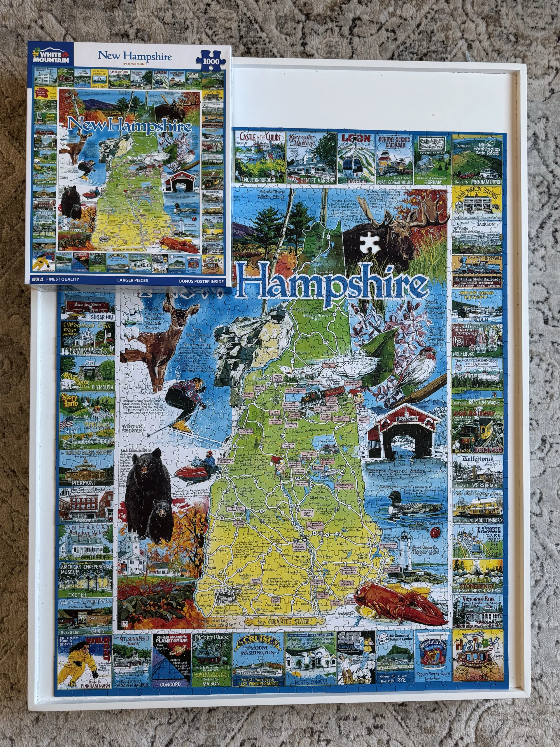 A completed puzzle of the State of New Hampshire surrounded by tourism attractions on a white puzzle board.
